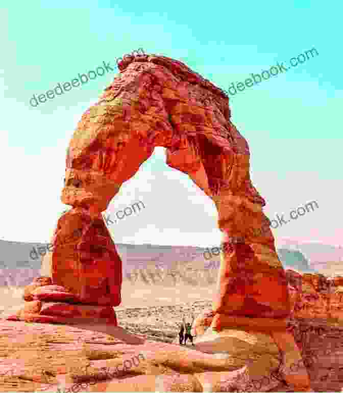 A Breathtaking Photograph Of Delicate Arch, A Free Standing Sandstone Arch In Arches National Park, Against A Backdrop Of Golden Cliffs And A Clear Blue Sky. Dreaming Of Arches National Park ( Dreaming Of )