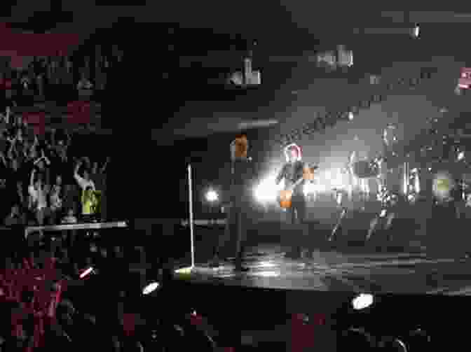 A Group Of Bon Jovi Fans Cheering And Waving Their Hands At A Concert Orbit: Bon Jovi
