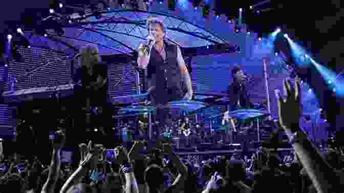 A Panoramic View Of A Bon Jovi Concert, With The Band Performing On Stage And The Crowd Cheering In The Background Orbit: Bon Jovi