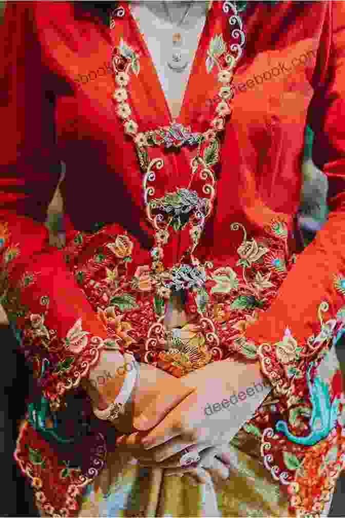 A Red And Gold Nyonya Kebaya Peranakan, Adorned With Intricate Embroidery Of Floral Motifs NYONYA KEBAYA PERANAKAN HERITAGE FASHION